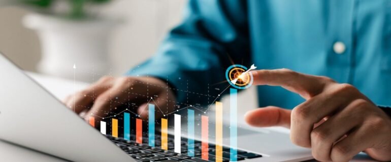 Man uses laptop and graph